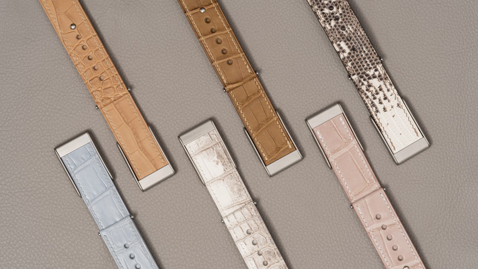 Black alligator leather band on an ivory surface