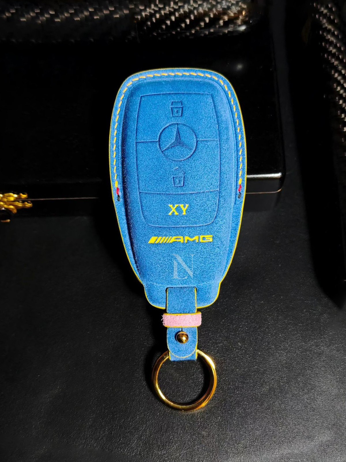 Blue suede Mercedes-AMG car key case with yellow stitching
