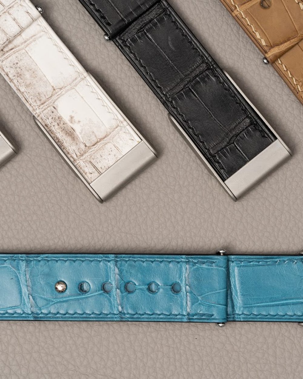 Noire Leathers crocodile straps laid out in the workshop